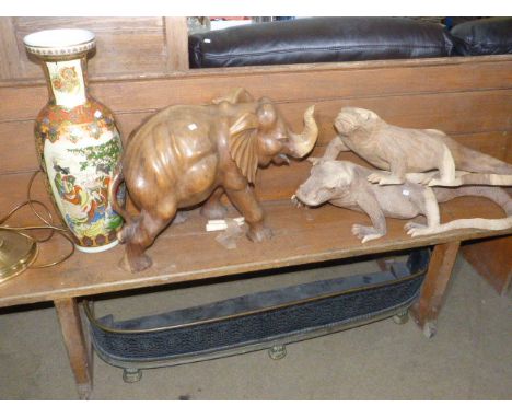 Two carved wood models of Komodo dragons, carved elephant, plant stand, large Oriental vase, brass standard lamp and kerb