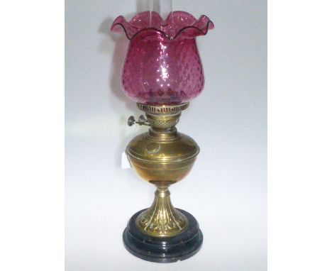 Brass oil lamp with ruby shade