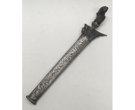 A 19th century kris, likely Malaysian in origin. Carved hardwood handle with gilt brass mount. Steel blade house in a repouse