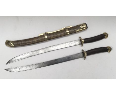 A 19th century Chinese Shuang jian paired swords or ‘butterfly knives’. Two short swords fitting back to back within one scab