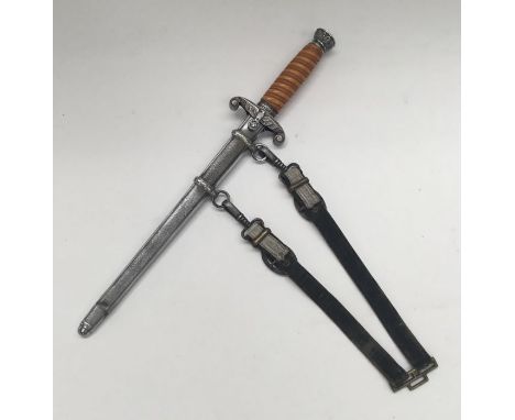 WW2 era German army officer’s dress dagger, with original hanging straps. Orange celluloid grip with oak leaf patterned nicke