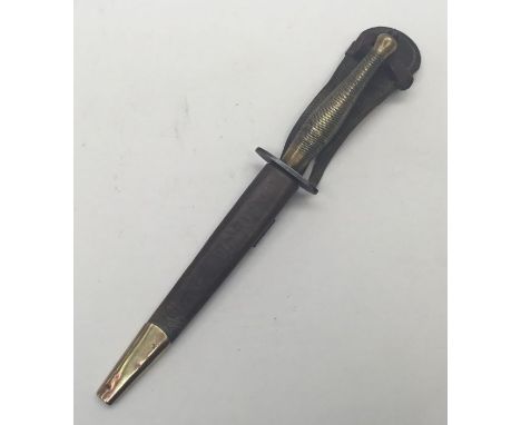 A WW2 era Fairbairn-Sykes commando knife, 2nd pattern. Brass grip with chequered or cross hatched detailing. Blued steel cros