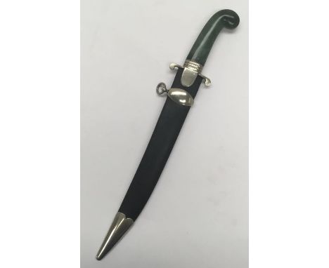 An unusual jade handled dagger, with associated scabbard. Nephrite jade handle with nickel mount and cross guard. Steel singl