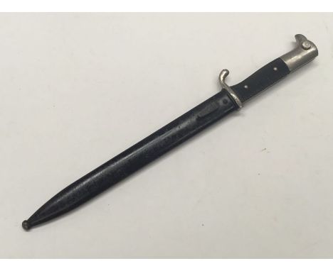 A WW2 era German dress bayonet with associated scabbard. Nickel plated pommel and cross guard, with red felt insert to the mo