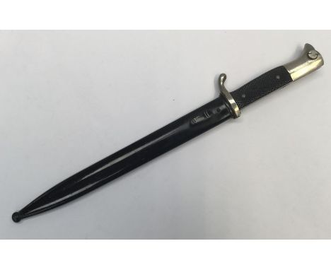 WW2 era German dress bayonet with associated scabbard. Nickel plated pommel, cross guard and blade, the latter single edged a