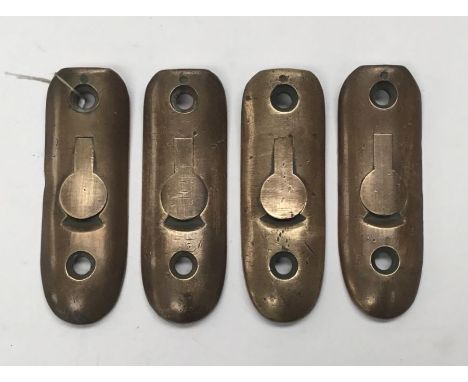 4 original brass butt plates with hinged tab for an oil bottle. Believed to be for the No.4 Enfield rifle. 3 of the plates ar