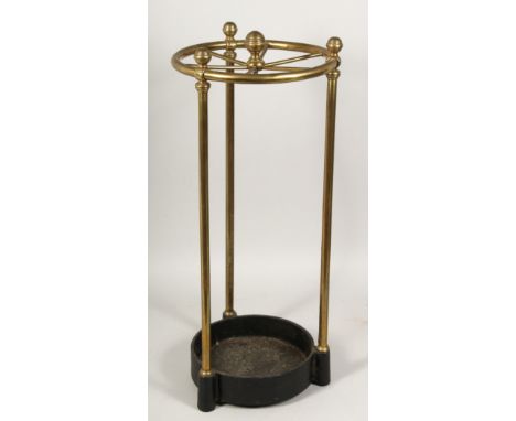 A BRASS STICK STAND on iron base 22ins high