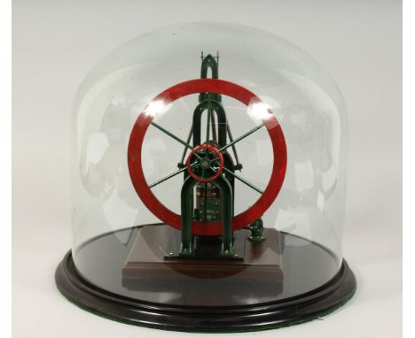 A MODEL STEAM ENGINE in a circular glass dome.