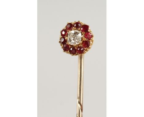A DIAMOND AND RUBY CLUSTER TIE PIN, cased.