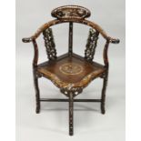 A CHINESE ROSEWOOD AND MOTHER OF PEARL CORNER CHAIR with solid seat.