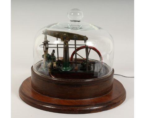 A MODEL STEAM ENGINE in a circular glass dome