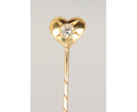 A DIAMOND SET HEART TIE PIN, cased.