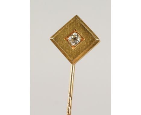 A GOLD AND DIAMOND SET TIE PIN, cased.