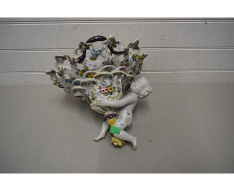 Continental ceramic lamp, the shade supported by a large cherub, lamp with floral design