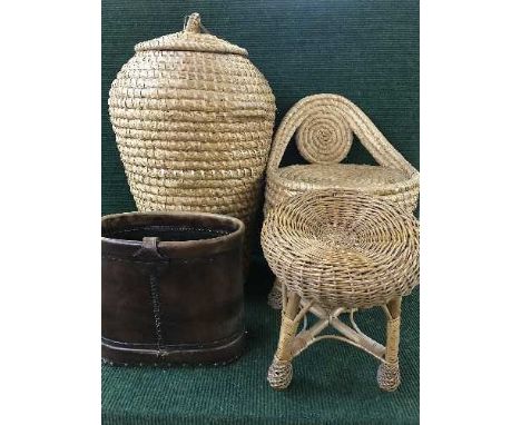 A wicker laundry basket, storage seat and leather stick stand 