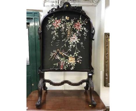 A Victorian heavily carved mahogany firescreen 
