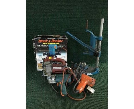 Two bundles of power tools, sash clamps, work bench