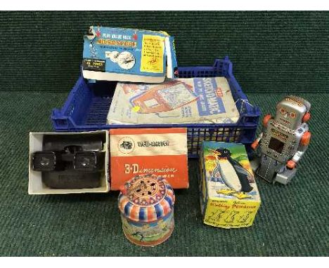 A box of mid twentieth century tin plate walking penguin and robot, play-value microscope, 3d viewer, boxed sketchomatic 