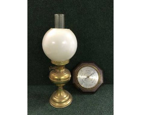 A brass Duplex oil lamp with glass shade and chimney together with an oak barometer 
