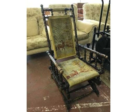 An American mahogany rocking chair upholstered in tapestry covering 