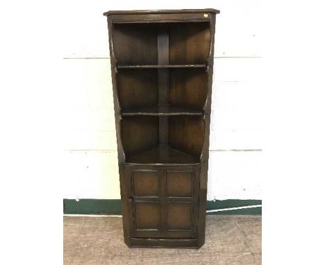 An Ercol corner cabinet 