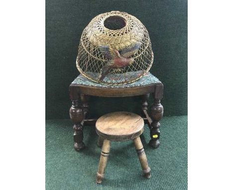 An early twentieth century oak dressing table stool together with a milking stool, 1930's wicker lamp shade depicting parrots