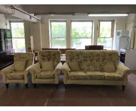 A three piece lounge suite upholstered in sand floral print 