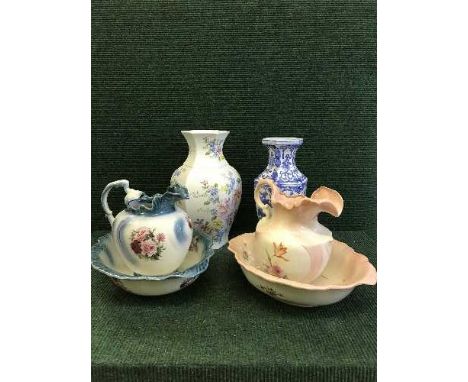 Two floral jug and basin sets together with a two floral patterned vases and lidded urn 