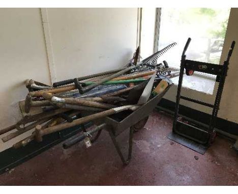A wheelbarrow containing a large quantity of garden tools together with a black and decker light weight sack barrow 