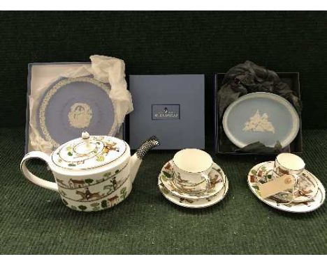 A tray of Wedgwood bone china teapot, cup and saucer, coffee cup and saucer and two plates depicting hunting scenes commissio