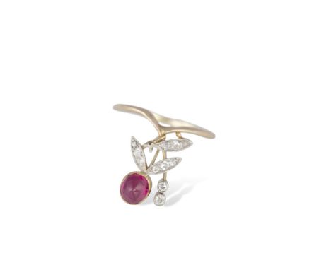 A RUBY AND DIAMOND RING, CIRCA 1920The collet-set round-shaped cabochon ruby, to old single-cut diamond leaf details, mounted