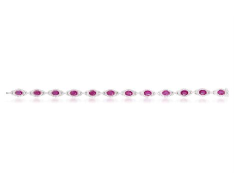 A RUBY AND DIAMOND BRACELETDesigned as an articulated line of twelve oval-shaped rubies, each within a round brilliant-cut di