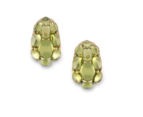 A PAIR OF PERIDOTS EARCLIPS, BY SEAMAN SCHEPPSEach earclip of bombé design, set throughout with graduating oval-shaped caboch