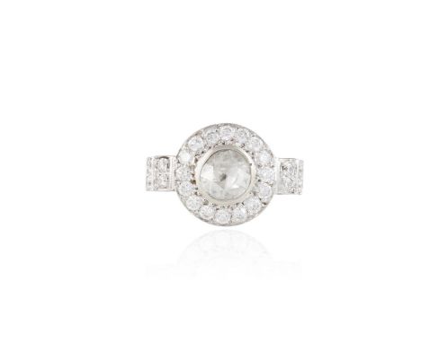 A DIAMOND DRESS RINGThe central collet-set rose-cut diamond, within a surround of round brilliant-cut diamonds and similarly-