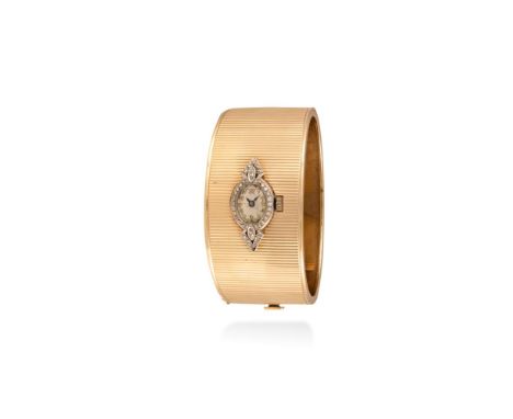 A GOLD AND PLATINUM BANGLE-BRACELET WATCH, CIRCA 1940The 17-jewel manual wind geometric millegrain-set platinum watch with ap