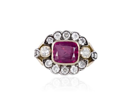 A RUBY AND DIAMOND RINGThe collet-set cushion-shaped ruby, weighing 3.70cts, within a surround of transitional round brillian