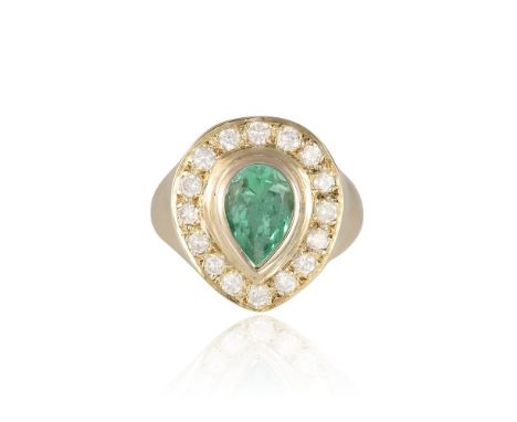 AN EMERALD AND DIAMOND DRESS RINGThe collet-set pear-shaped emerald, within a surround of round brilliant-cut diamonds, mount