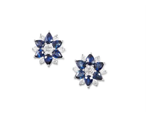 A PAIR OF SAPPHIRE AND DIAMOND CLUSTER EARRINGSEach designed as a stylised flowerhead, centrally-set with a round brilliant-c