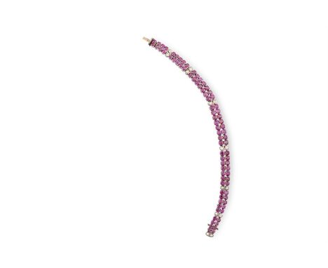 A RUBY AND DIAMOND BRACELETThe double-row of circular-cut rubies, highlighted by similarly-cut diamond links, length 18cm