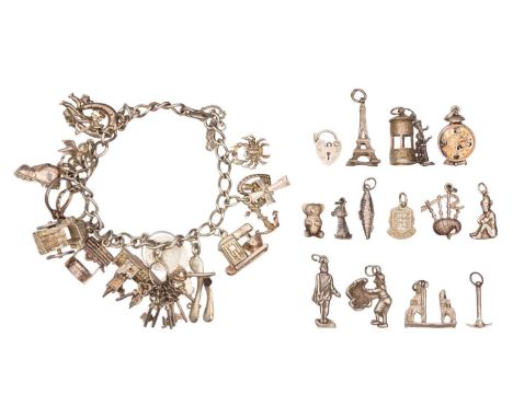 A silver charm bracelet with a selection of other charms. The bracelet has a spring clasp and a safety chain, 7" approx., wit
