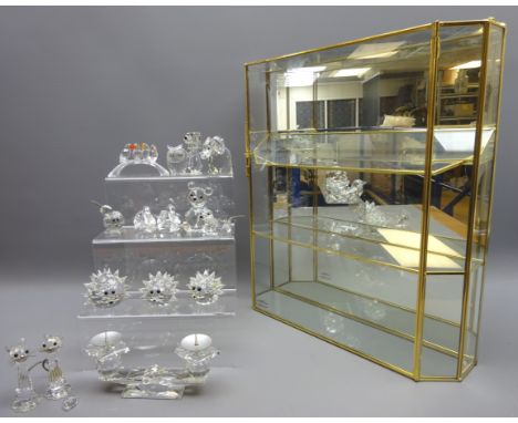 Fourteen Swarovski figures of animals and birds, a two sconce candelabra and a small glazed mirror backed display cabinet Con