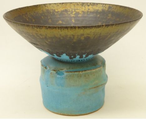 Studio pottery footed vase decorated with turquoise and bronzed manganese rim, on large cylindrical base, in the style of Luc