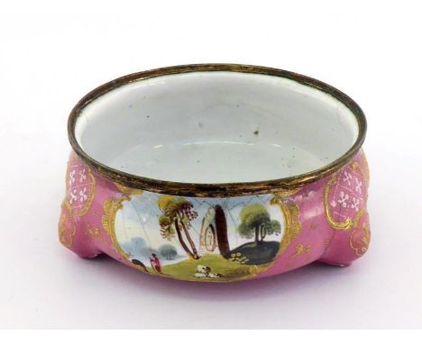An 18th. century enamelled cauldron salt with applied gilt rim on three rudimentary stump feet, the pink enamel body with vig