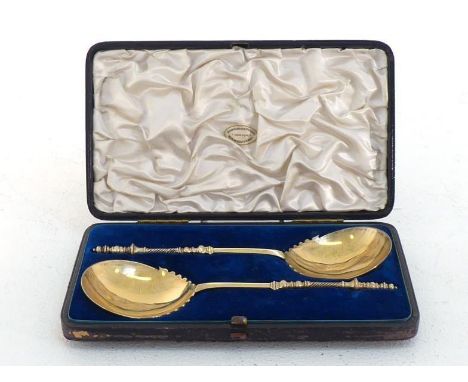 A pair of late Victorian silver-gilt serving spoons modelled after 17th century Dutch bobbin finial spoons, by Walker & Tolhu