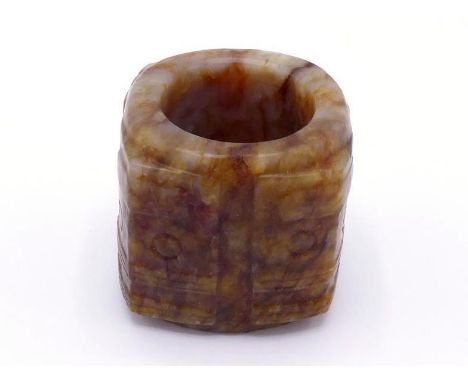 A Chinese carved jade archer ring, in the form of “Cong” engraved masks pattern on each corner, brown surface with occasional