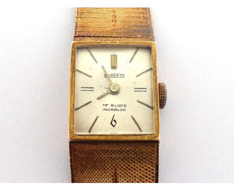 A 14 carat gold lady's wristwatch, the rectangular case with silvered dial and baton numerals, with 17 jewel manual wind move