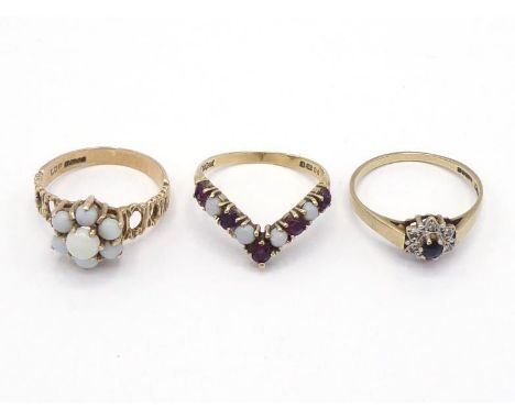 Three 9 carat gold and gem set rings, including an opal set example with openwork shank, finger size O; an opal and garnet wi