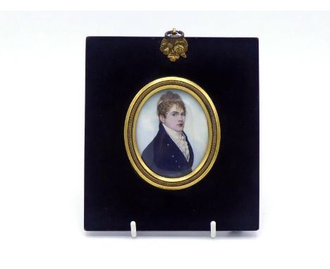 Attributed to Frederick Buck (1771-c.1839). A portrait  miniature of a red-headed gentleman in dark blue coat and white waist