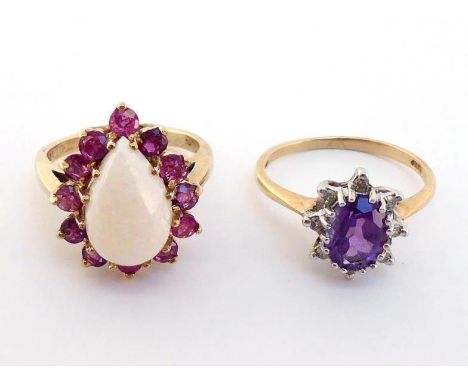 Two 9 carat gold gem set rings, the first an opal and garnet cluster, the pear cut opal 8.3 x 13.1mm, in a surround of garnet