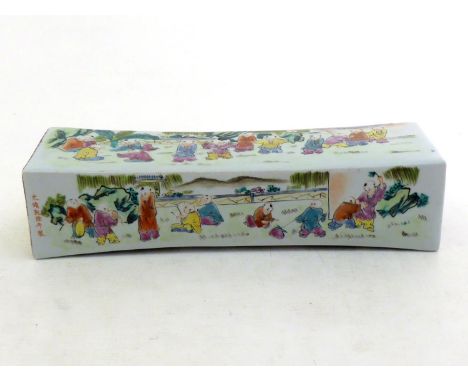 A Chinese famille-verte ceramic in pillow form, decorating “playing children” on each side. Qianlong mark but modern. 34cm lo